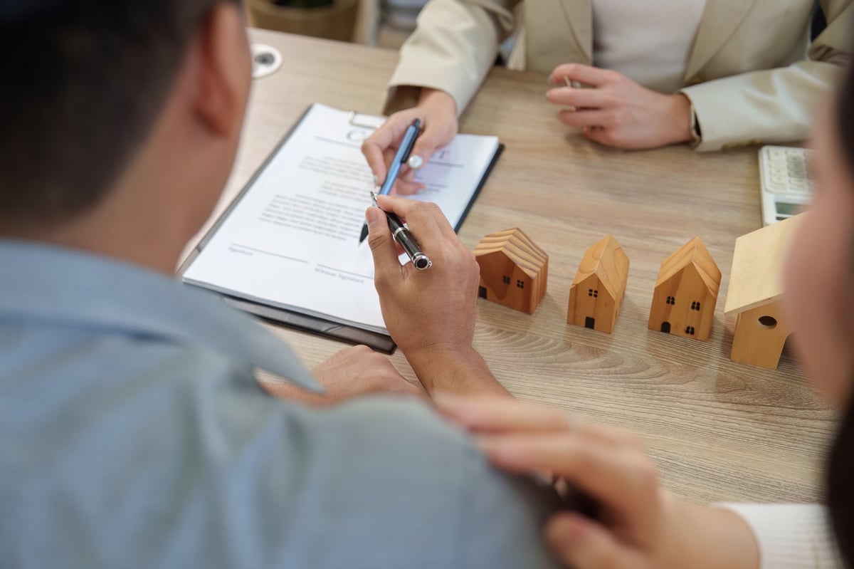 A housing coordinator reviewing property details with a partner in a living room