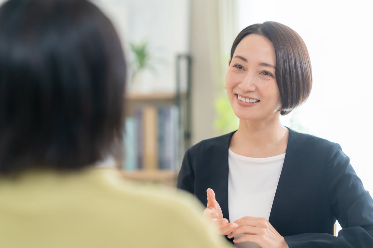 Two people discussing housing options in a comfortable living room setting