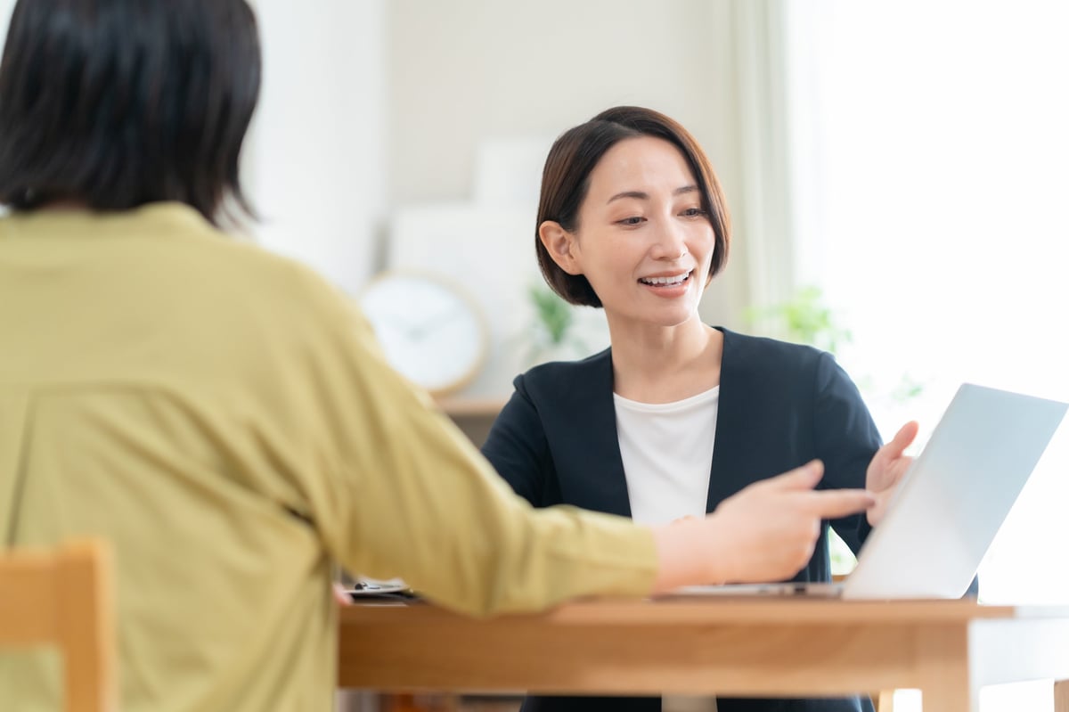 Two people discussing partnership details in a comfortable living room setting